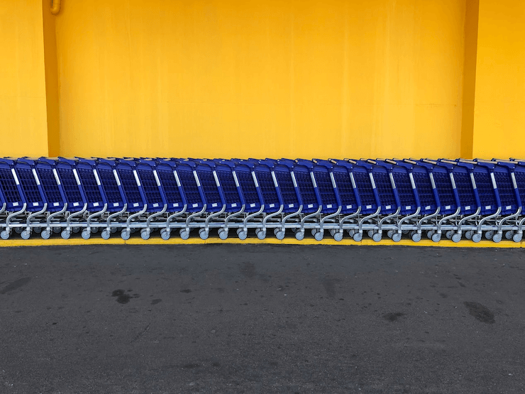 A line of carts standing near a shop